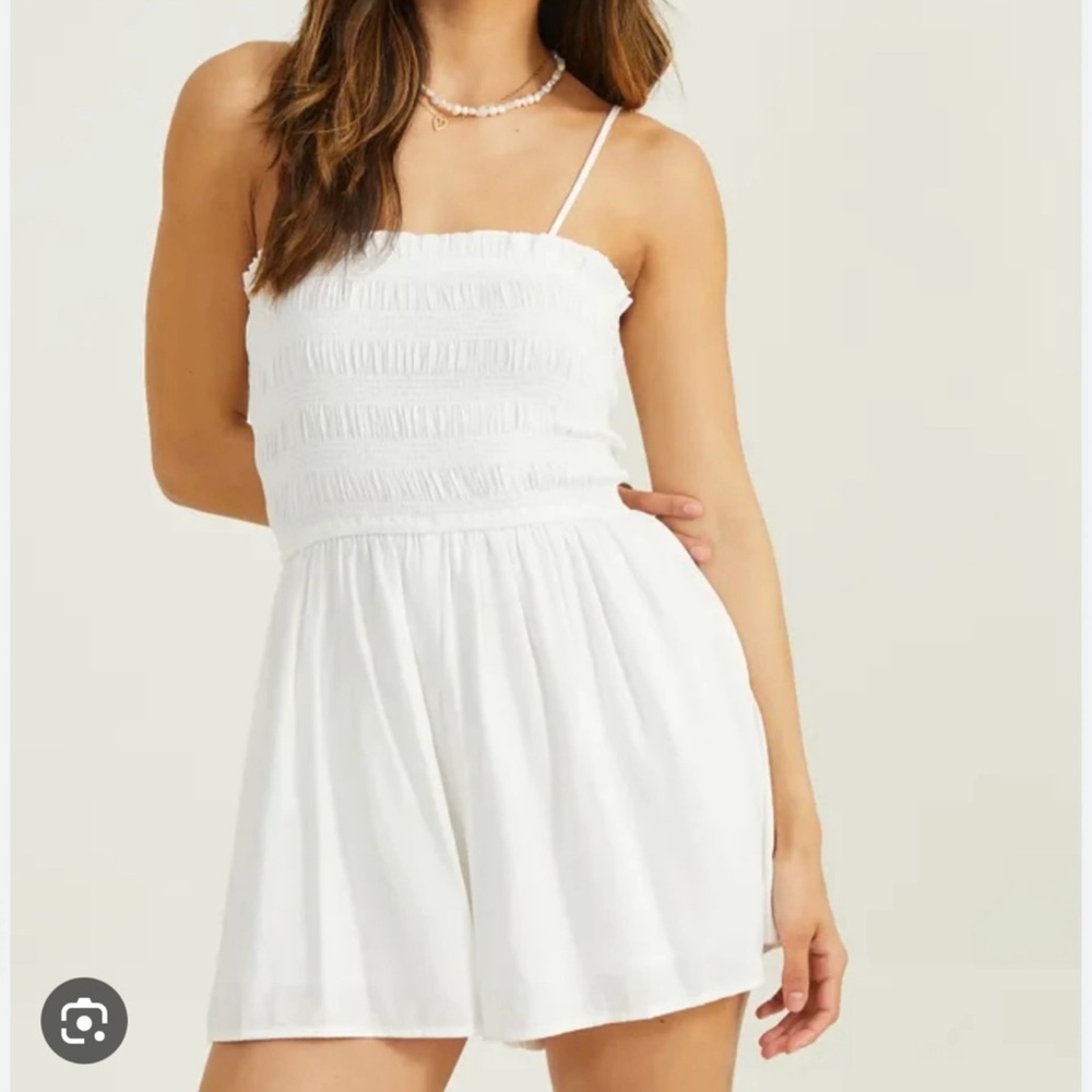 Cute White Romper with Elastic bands on the back.